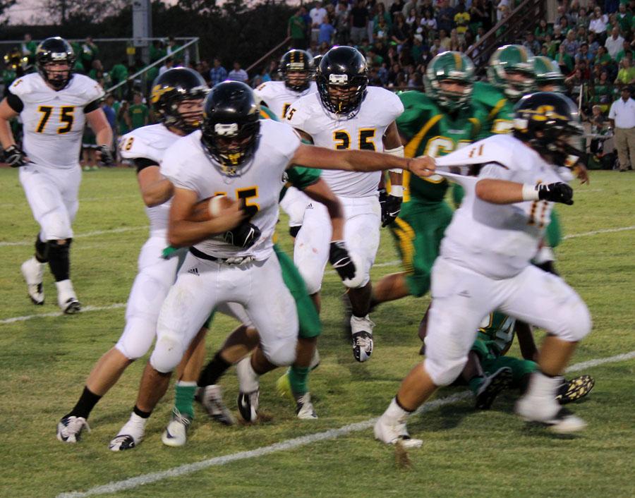 Quarterback junior Grant Petty takes guidance from his fullback blocker, junior Dustin Lira, to gain yardage against Idalou on Sept. 6. Petty was the leading rusher for the Indians with 91 on 21 carries in the 21-7 loss to the Wildcats.