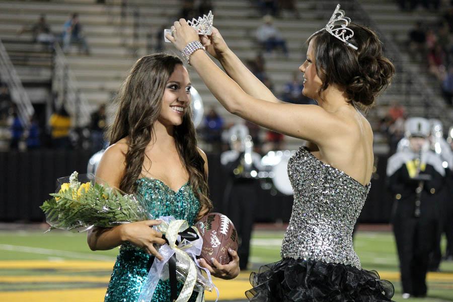 Senior Morgan Jones accepts her crown from 2012 homecoming Queen Tara Parkey. Jones was crowned at halftime of the Fort Stockton game.