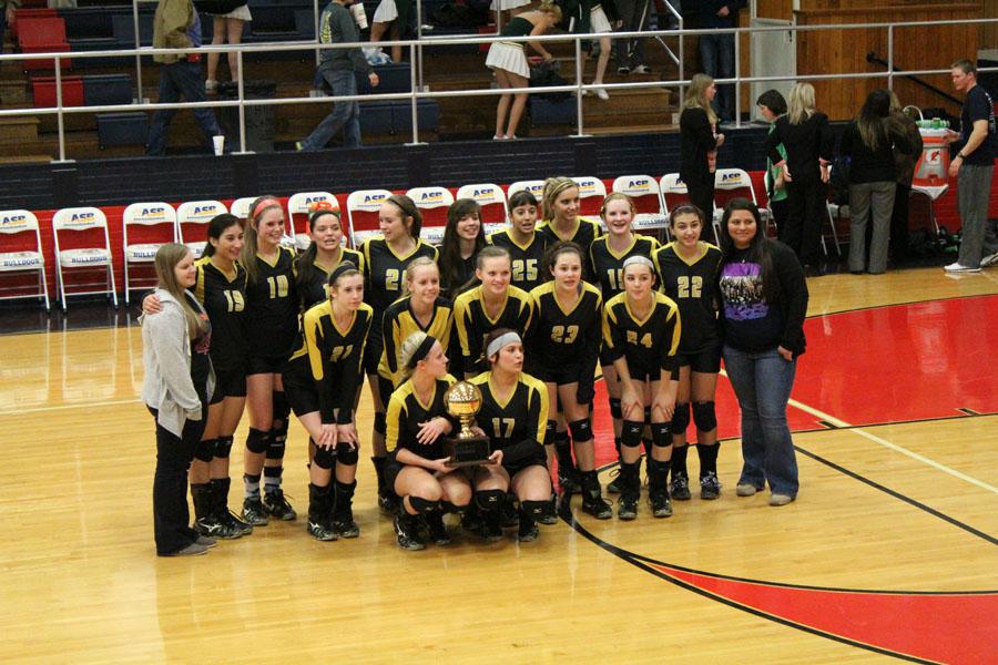 The Maidens take the trophy for bi-district champions after defeating Pampa on Nov. 5. The Maidens won in three games, 25-22, 25-17, 27-25.