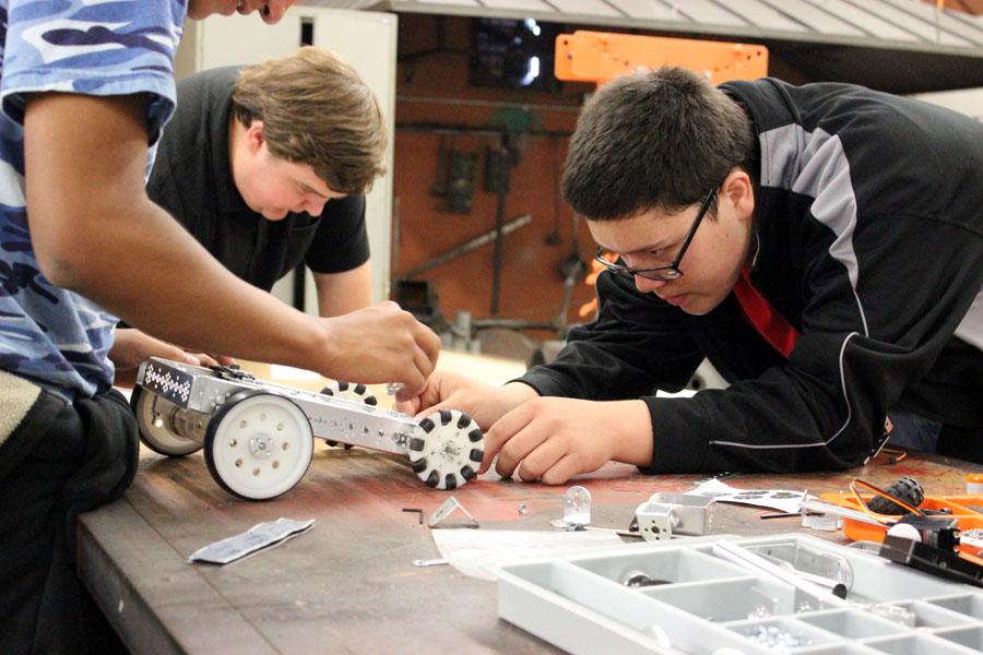 Technical work
Juniors Josh Palomo,  Ernie Loewen and freshman Max Wiebe put together wheels and base for their groups’ robot during second period construction engineering class. The students will have the opportunity to go to contest with their projects.