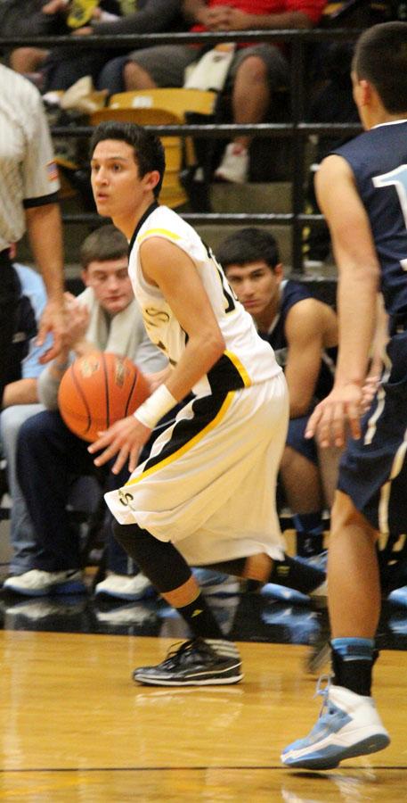 Looking for
loopholes--
Senior guard Michael Garza works the offense furing the first half of the Dec. 17 win over Greenwood. Garza had 14 points including three three-pointers.
