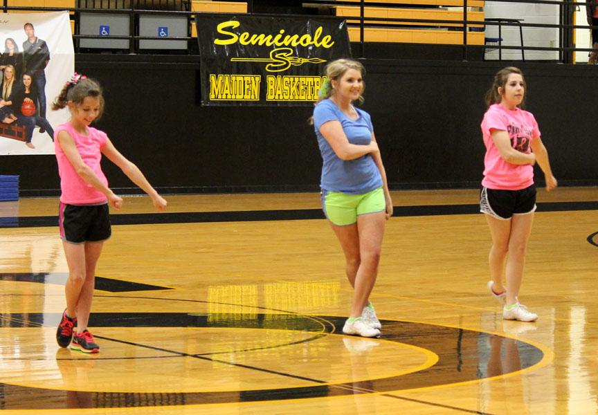 Shout tryout--
Eighth grader Abby Fehr, sophomore Bailey Pierce and junior Shasta Pettyjohn perform for the student body during assembly time on Feb. 26. The three tried out before judges with the other 18 contestants at 4 p.m. that afternoon.