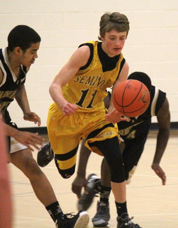 Fast break--
Freshman guard Brett Hicks takes the ball downcourt at a sprint during the victory over Andrews on Feb. 3