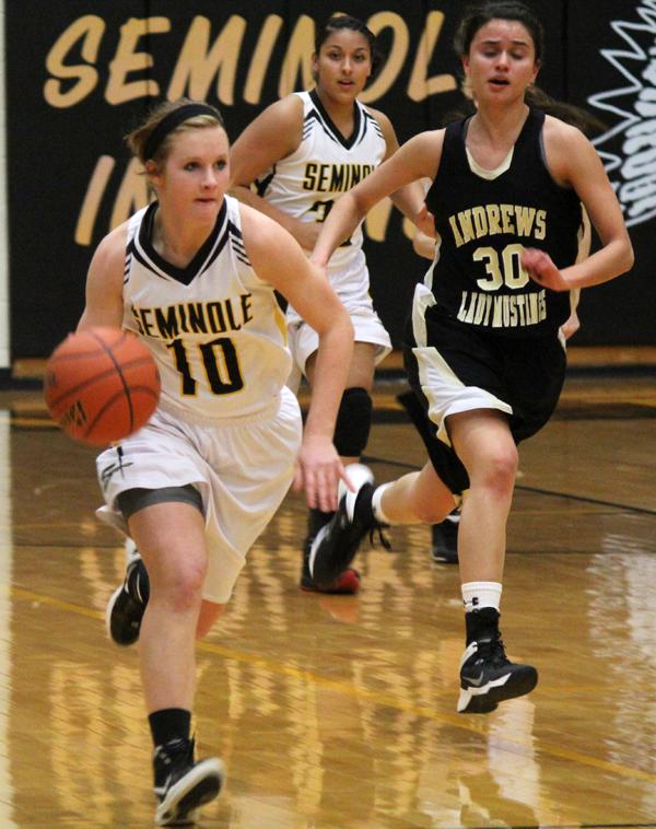 Looking 
downcourt--
Sophomore guard Lindsey Wimmer takes the ball to the offensive end during the last district game versus Andrews on Feb. 4.
Wimmer had 14 points in the Maidens’ 80-15 victory.