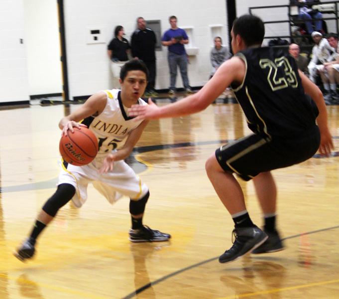 Getting by--
Senior guard Michael Garza runs the offense against Andrews on Feb. 4. Garza had eight points in the 55-43 Indian victory.