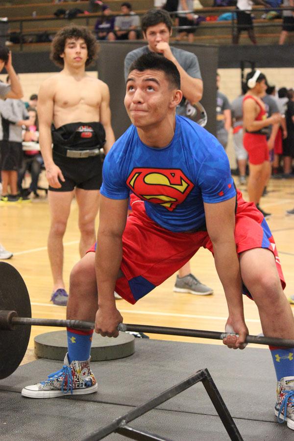 Three-peat--
Junior Andrew Alvidrez dead lifts in full Superman attire at the home meet in February. Alvidrez took first place at the regional meet to qualify for state for a third year in a row.