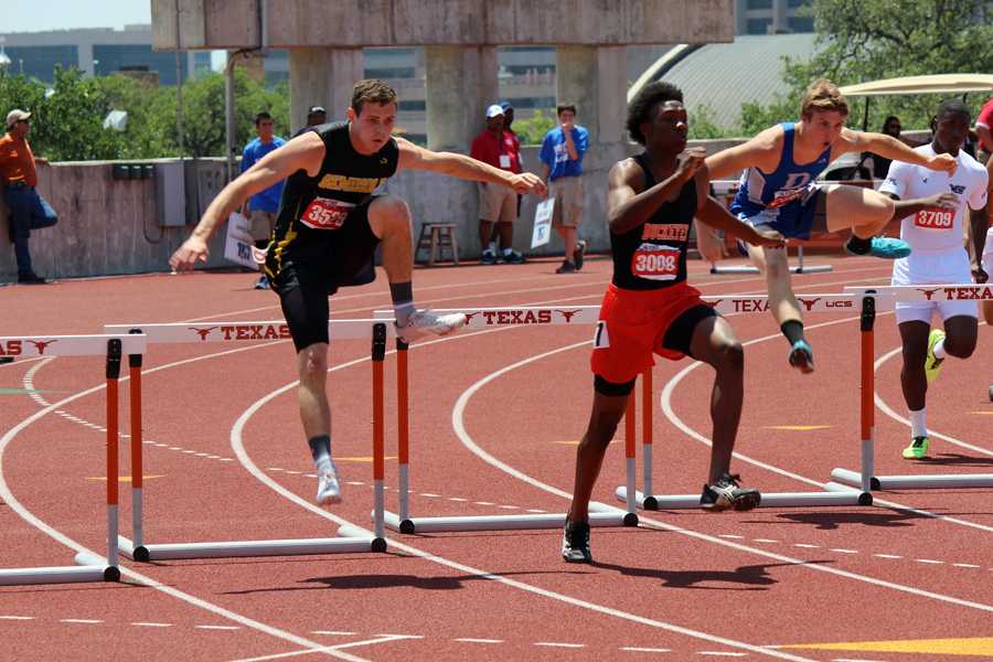 So close--
Senior Trevor Greenfield  leaps over hurdles at Mike A. Myers Stadium during the 300-meter hurdles competition on May 10. Greenfield took second place to J.J. Jackson of Caldwell High School (right).
