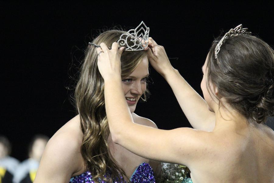 Crowning glory--
Senior Susan Reimer is crowned by 2014 Queen Morgan Jones at halftime of the football game on Oct. 3.