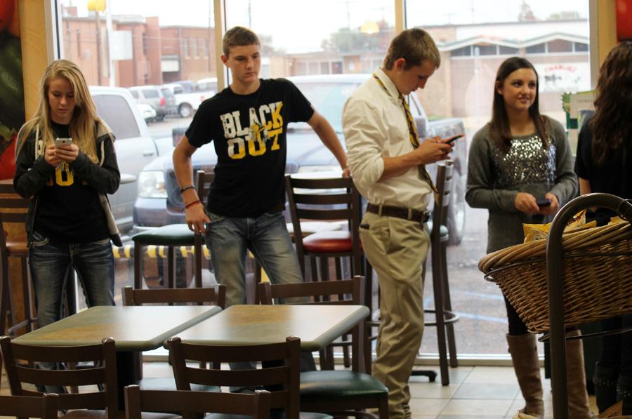 Waiting it out--
Students pass time in the line at Subway on Sept. 19. The one-lunch schedule crowded restaurants and cafeteria lines alike.