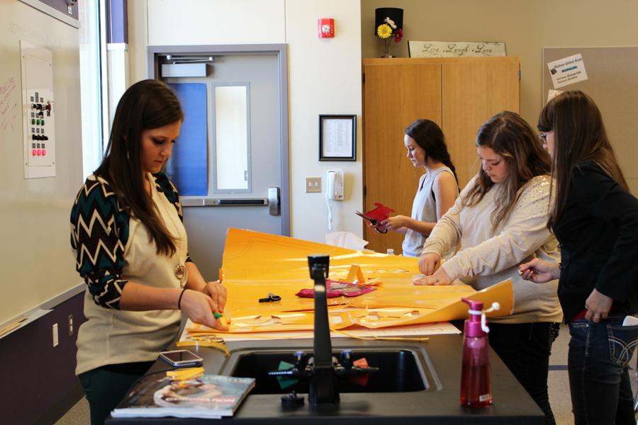 Getting ready--
StuCo president senior Brooke McCormick helps members with decorations on Sept. 29. StuCo members worked all week and most of Oct. 3 morning  with the circus decorations.