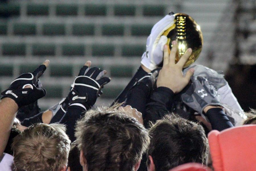 Golden moment--
Indian players hold the bi-district trophy aloft on Nov. 14. The Indians defeated Fabens, 35-0, in Monahans.