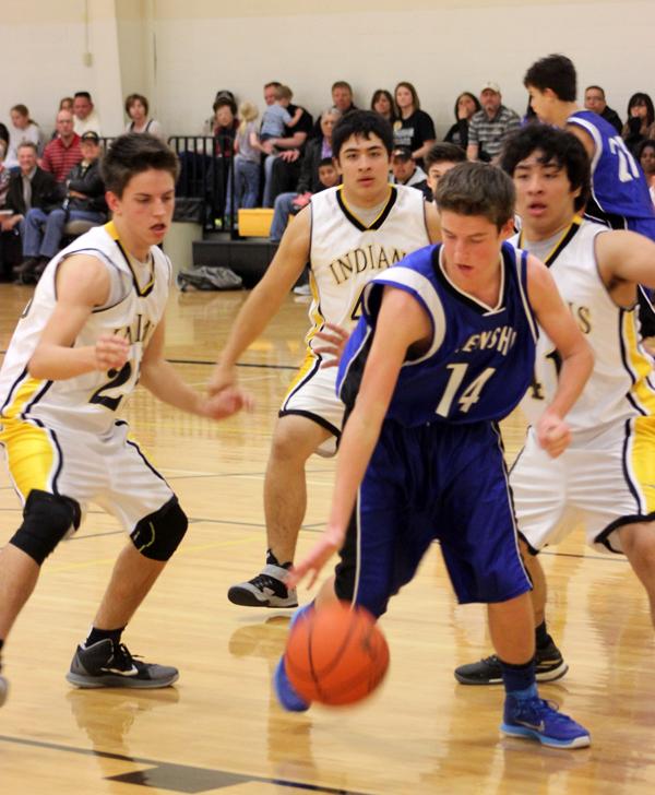 Wall of defense--
Freshmen Indians surround a Frenship player on Dec. 9. The Indians fell to the Tigers, 56-25.