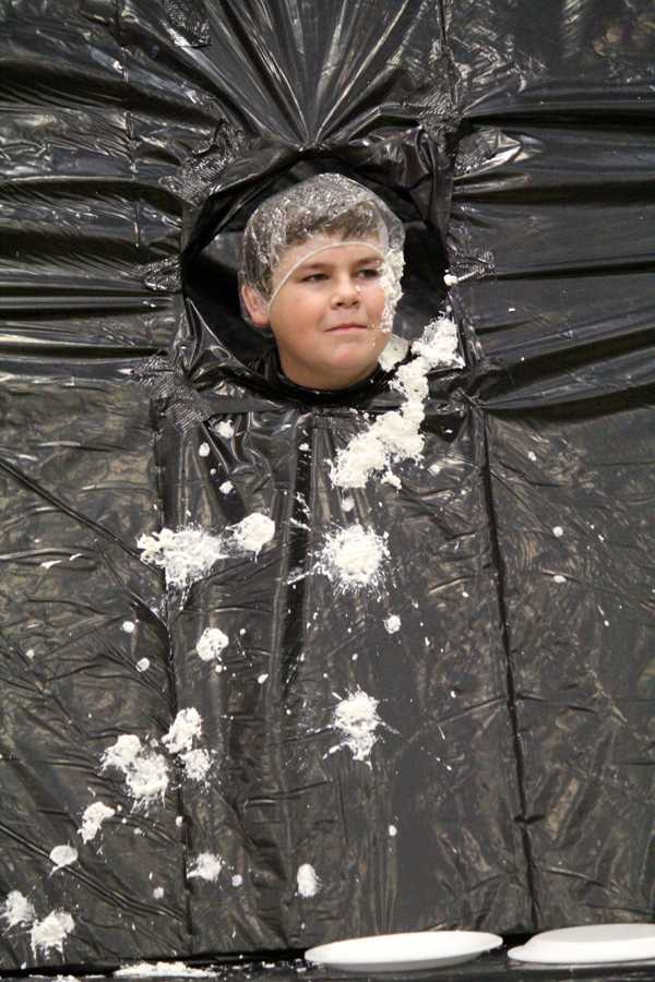Missed me--
Junior Bailey Seay taunts his attackers at the student councils pie throw booth during the fall festival.