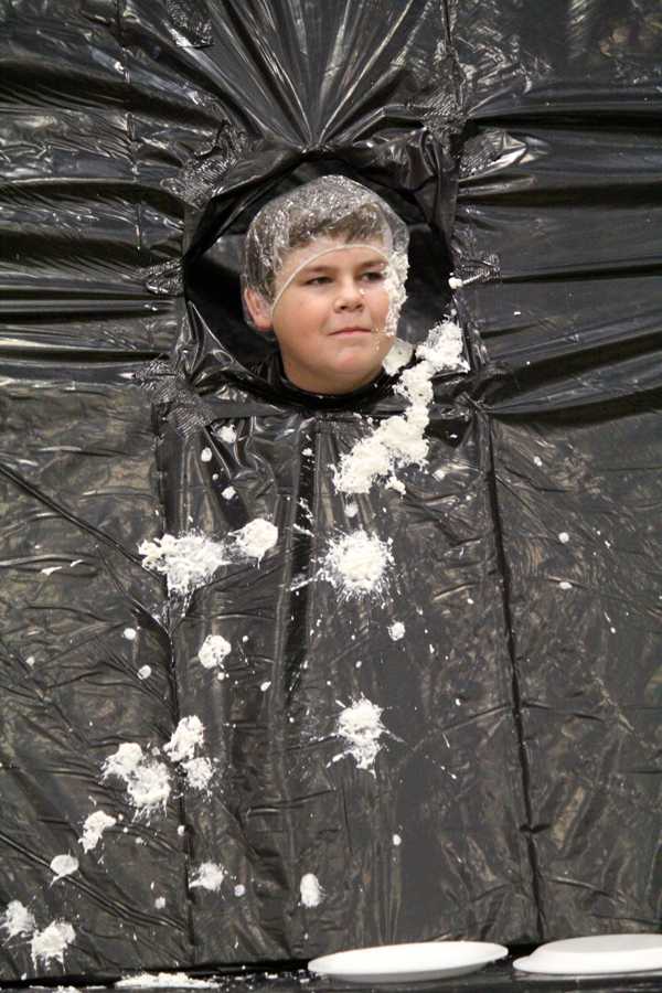 Missed me--
Junior Bailey Seay taunts his attackers at the student council's pie throw booth during the fall festival.