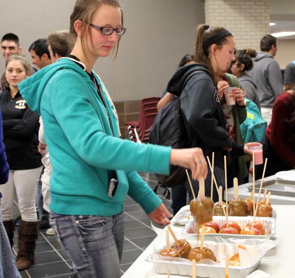 Looks good--
Junior Judy Hildebrand picks out a carmel apple at the National Honor Society booth during fall festival.