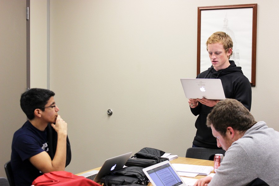 Getting ready--
Senior Jimmie Vaughn reads a case to his partner senior Kyle Rickman and junior Chris Arzate during ninth period debate class on Feb. 2. The three and three other SHS debaters will compete in district on Feb. 2.