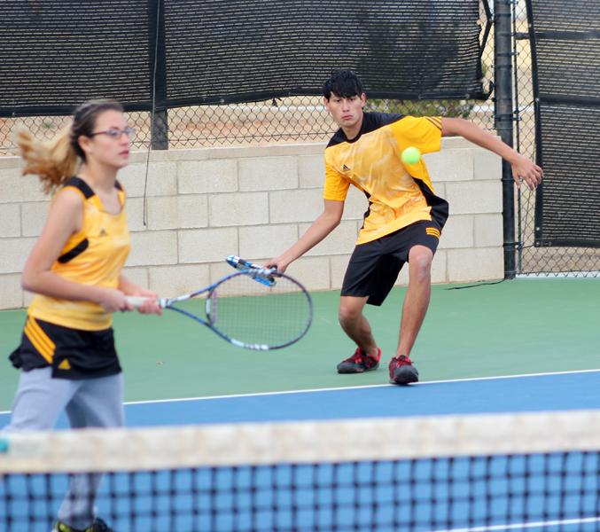 Back attcha--
Sophomore Chris Owen returns serve to a Greenwood player during a practice match on Jan. 29. Owen and sister senior Aubrey Owen became doubles partners this season.