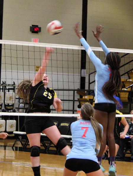 Take that--Freshman Rebekah Guenther gets a kill against Monterey on Sept. 15. The Maidens took the win, 25-23, 25-20.