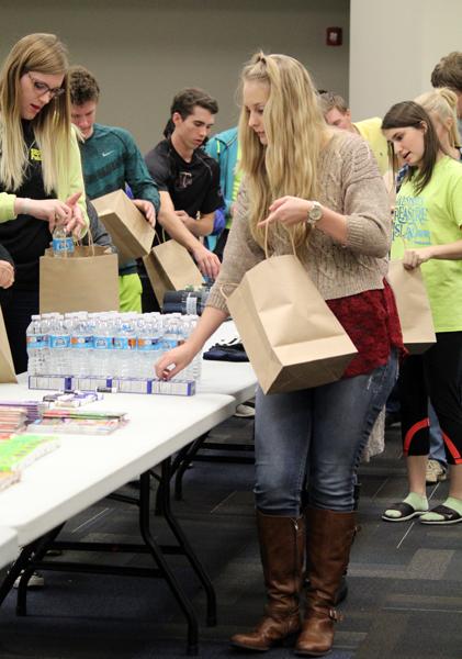 Chemo care--
NHS members form an assembly line on Nov. 23 while putting together care packages for chemotherapy patients. The care packages were funded by the powder puff football game.