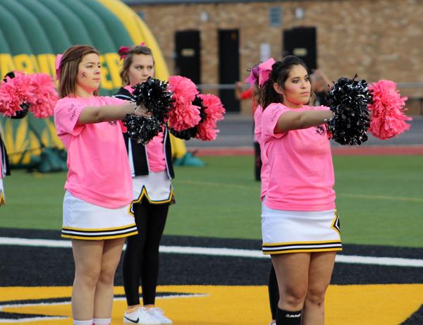 Beginning song
Junior Kaitlyn Hogue and senior Tori Acosta perform the school song before the pink-out game on Oct. 16.