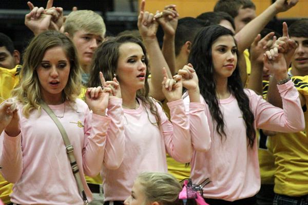 Pretty in pink
Volleyball players junior Cambri Addison, junoior Brogan Purser and freshman Chloe Gonzalez sing the school song at the pink-out pep rally.