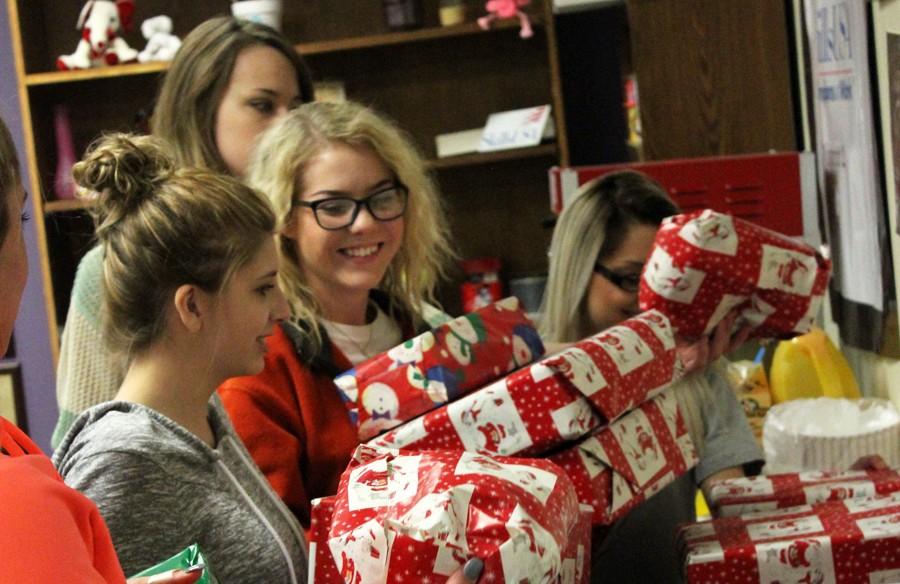 Playing Santa
SkillsUSA Cosmetology juniors Martha Friesen, Kristy Grijalva,  Lisa Unger and Amanda Neudorf stack packages they wrapped for  Mental Health and Mental Retardation clients during third period on Dec. 7. The SkillsUSA group plays Santa for the MHMR center each year.