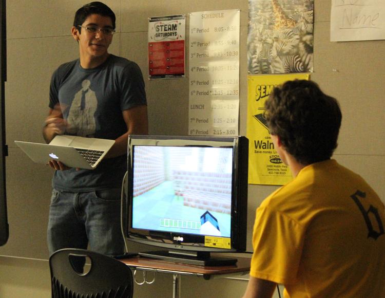 New twist
Seniors Chris Arzate and Royce Snethen present their project to their Biology II class during first period on Oct. 29. The project of building a cell to look like a miniature golf course inspired them to create it in the video game Mindcraft.
