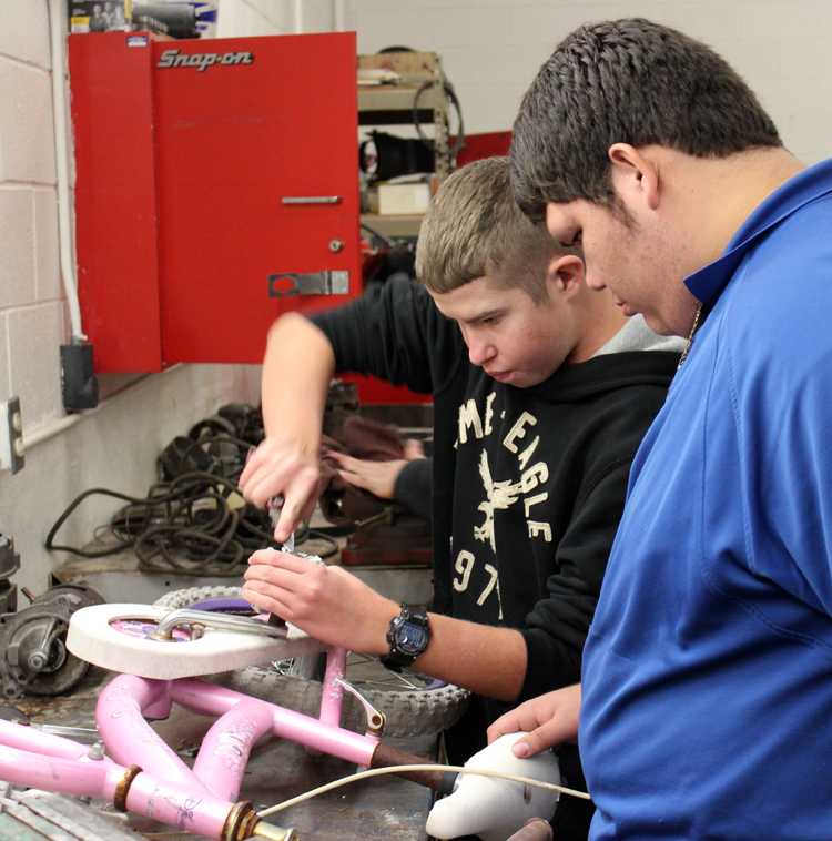 For the kids
Sophomores Justin Froese and Elias Heredia repair a pedal on a bicycle frame during fifth period automechanics. The bike was part of the national-qualifying Give a Child a Smile community service project.