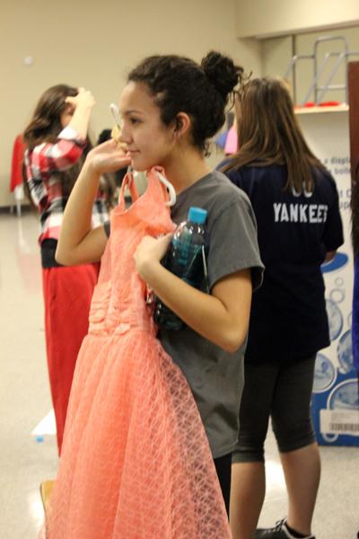 Final fitting--
Junior Lauren Franco  looks through costume choices for her role in the chorus of Grease during practice on Jan. 14. Cast members worked for weeks  in rehearsal to perfect the show