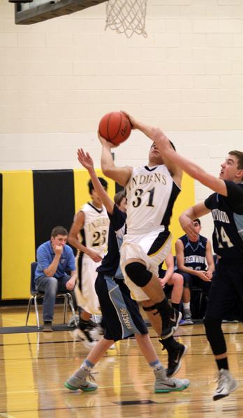 Through a crowd--
Sophomore Daniel Grado fights for a layup during district play against Greenwood on Feb. 2. The Indians fell, 42-37, to the Rangers.