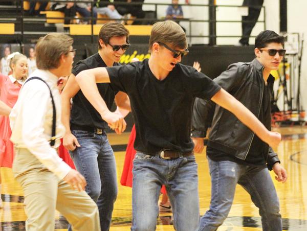 Drumming up business--
Grease chorus members, senior Kolt Blackmon, sophomore Ransom Edwards, sophomore Bryce Karr and freshman Dillon Gutierrez perform at the  Jan. 22 pep rally. The theater department also put up placards all over the building to draw interest to the musical.