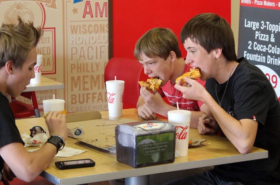 Quick and affordable--
Sophomores Tyler Redcap, Steven Elias and Jeremiah Harms inhale a pizza at Dominos for lunch.