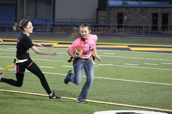 Here she comes--
Senior Heidi Froese takes the ball around the corner during the powder puff game on Nov. 4. The senior team won the charity benefit, 18-12.