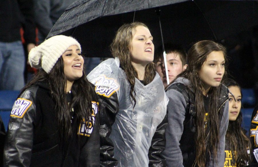 Front+row+seats--%0ASenior+fans+Yanomi+Garcia%2C+Crystal+Froese+and+Adriana+Romero+lean+over+the+rail+during+the+Nov.+25+region+quarterfinal+football+game.+Fans+braved+cold+and+rain+to+see+the+Indians+take+a+28-20+win+over+district+champion+Monahans.