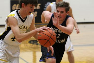 Speed play--
Freshman Earl Neufeld blows by a Midland High player during the 48-45 loss on Dec. 13.