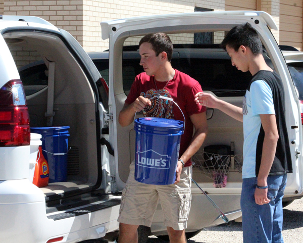 Helping hands--
Juniors Jordan Rodriguez and Steven Lin load hurricane clean-up buckets into a vehicle for transport on Sept. 20. Students raised money to help those hit by Hurricane Harvey on the Texas coast.