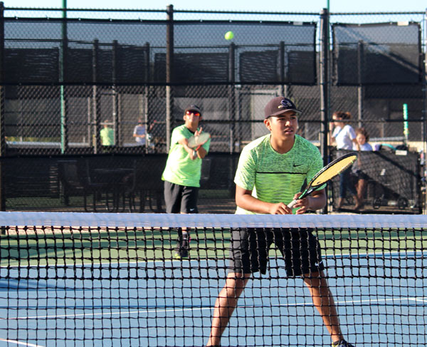 Getting ready--
Junior Chris Lopez Delgado waits at the net as his doubles partner senior Sebastian Salazar serves during non-district play on Oct. 14. The partners went on to win in bi-district play the following Tuesday against Borger.