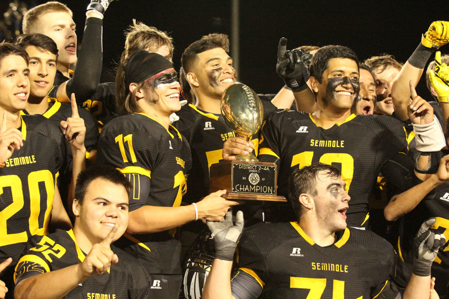 District champs--
Indian football players celebrate a district championship with the trophy after defeating Fort Stockton, 41-7, in the last district game. 