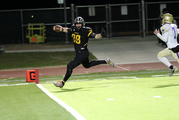 End zone effort--
Senior tight end Reese Moore scores his second touchdown at the beginning of the second quarter in bi-district play against Dalhart. Moore had two touchdowns in the 43-6 win over the Golden Wolves in Portales, N.M. on Nov. 16.