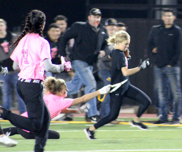 Not so fast
Senior Caanon Gibbons grabs junior Taylor McGehee’s flag as she runs the ball during the National Honor Society’s charity game to help chemotherapy patients.  The senior team took the win, 13-0.  