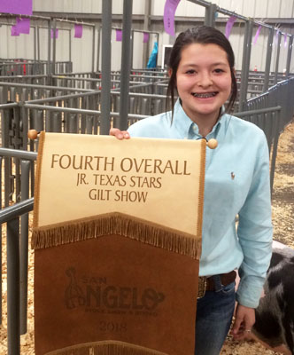 Wooly winner--Junior High FFA member Briana Foote brings home the champion Poland China gilt banner from the San Angelo Stock Show.