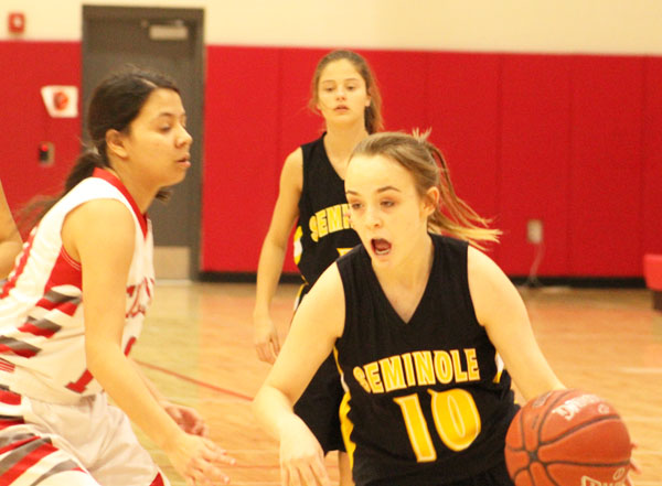 Moving the ball--Freshman guard Jessie Beaubien dribbles past a Denver City defender during district play on Jan. 30. The Maiden loss to the Fillies moved their district record to 4-4.