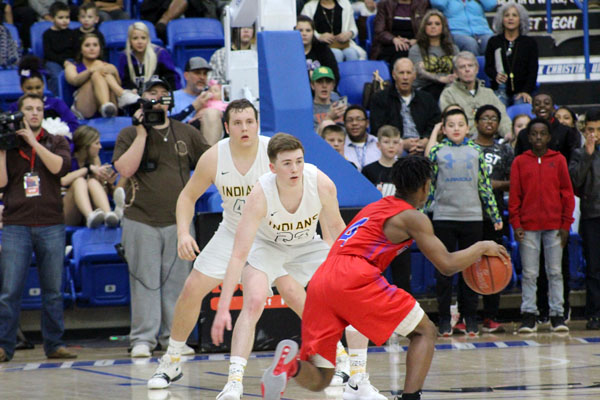 Not this time--Senior post Reese Moore and senior guard Carter Johnson keep  their eyes on Heritages Kerrion Fields in the fourth quarter of the region semis on March 2. Fields hit the buzzer beater in 2017 that knocked the Indians out in the region finals.