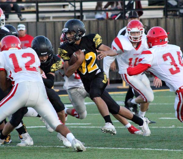 Look for an opening--
Sophomore running back Emilio Aguilar looks threads his way through the Mustang defense during the 30-12 win over Denver City on Sept. 27.