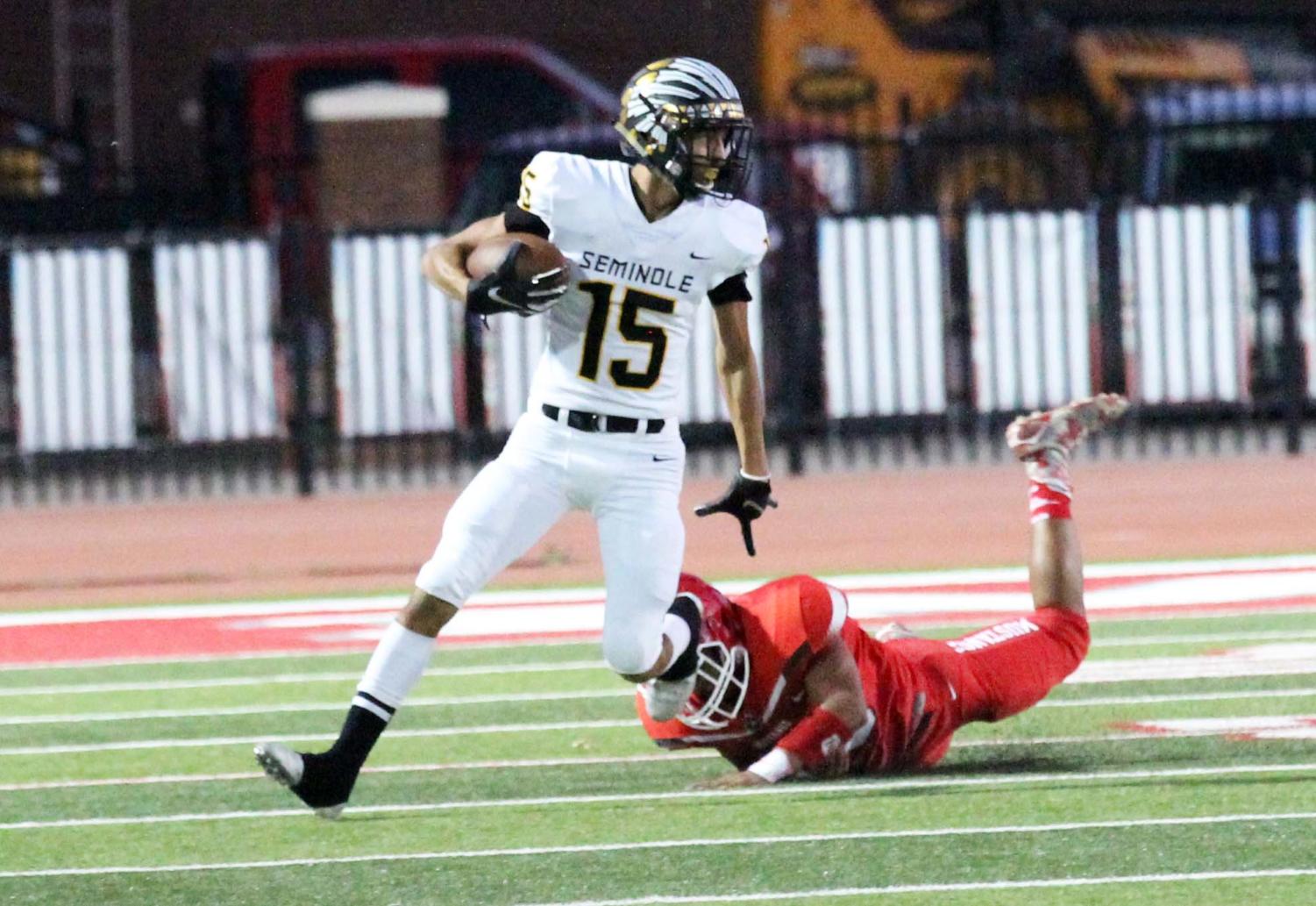 Evading the defense--
Senior wide reciever James Hurston side steps a Mustang defender as he returns a punt during preseason play again Denver City on Sept. 28. Hurston scored 12 points for the Indians on two touchdown passes from senior quarterback Jordan Matthews.