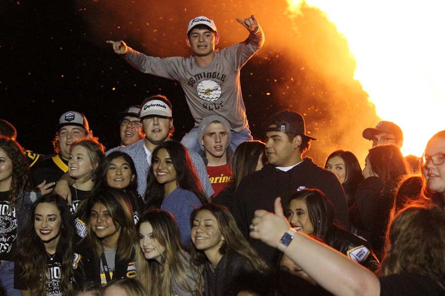 Last time--
Seniors pose for photos in front of the bonfire at the rodeo grounds on Oct. 11.