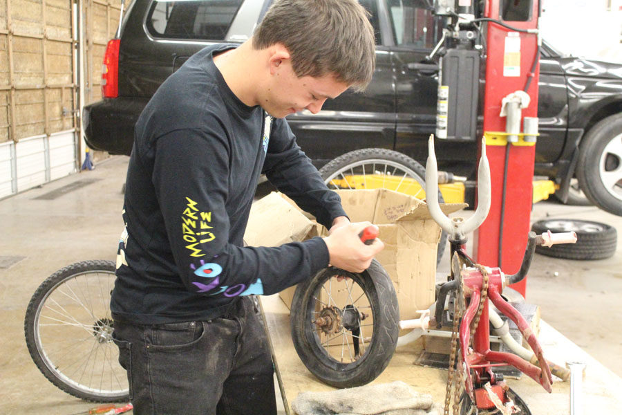 Yule retool--
Senior Herman Pipkin works on a tire for a bicycle in fifth period auto tech class. The bicycle was one of approximately 43 to be delivered to underprivileged children with the Give a Child a Smile service project for SkillsUSA.