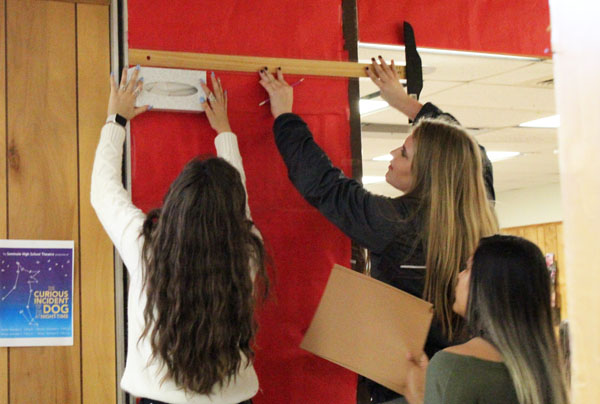 Holiday cheer--
During second period world history, sophomores Aaliyah Ericson, Reese Cooper and Elizabeth Jurado work on their How the Grinch Stole Christmas-themed door on Oct. 26.