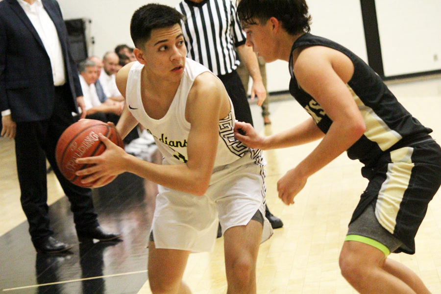 Wait for it--
Senior guard Jesus Perez Dominguez looks for a passing opportunity during district play against Andrews on Feb. 5. The Indians took the win to maintain sole possession of first place.