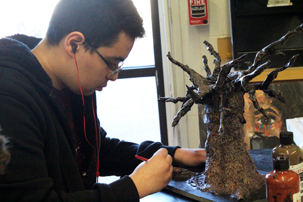 Adding color--
Junior Diego Flores paints his sculpture during third period class on Jan. 24. VASE entrants were required to submit an original piece of art as well as be interviewed at the region event by a judge. 